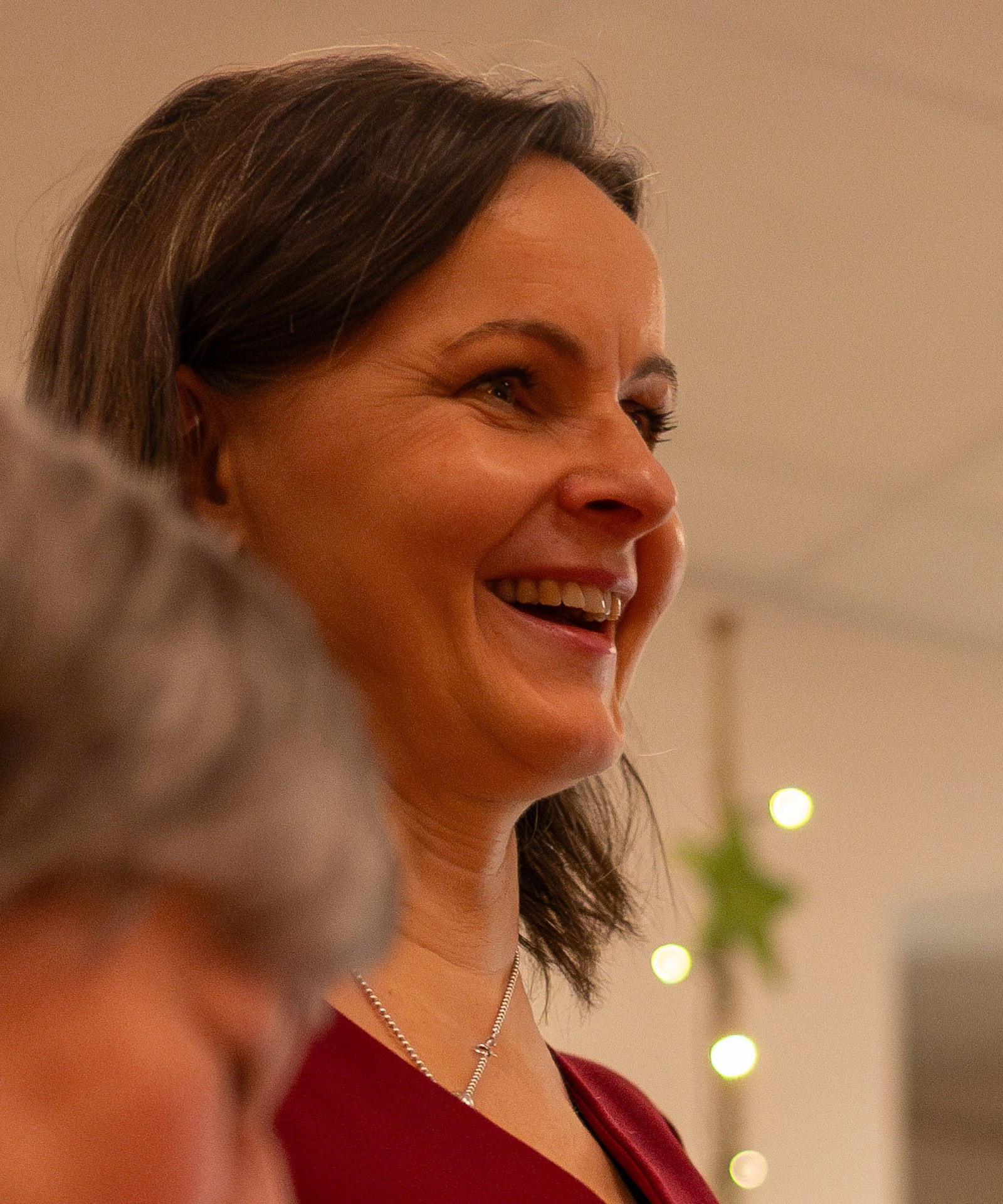 Frau lacht herzlich bei einer Weihnachtsfeier